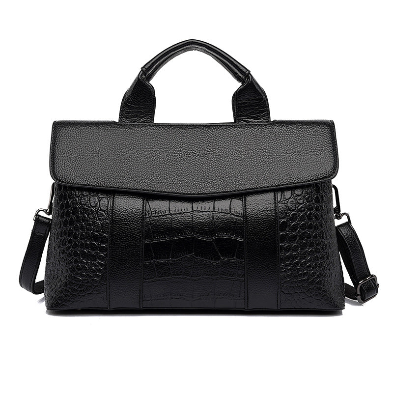 Black embossed leather-look handbag, top handle with crossbody straps and flap