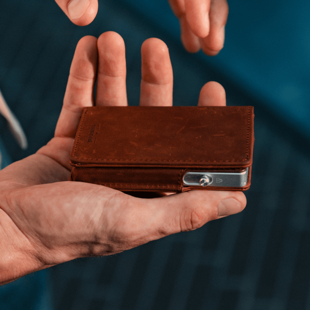 Brown leather bifold wallet with stitched front and metal snap clasp