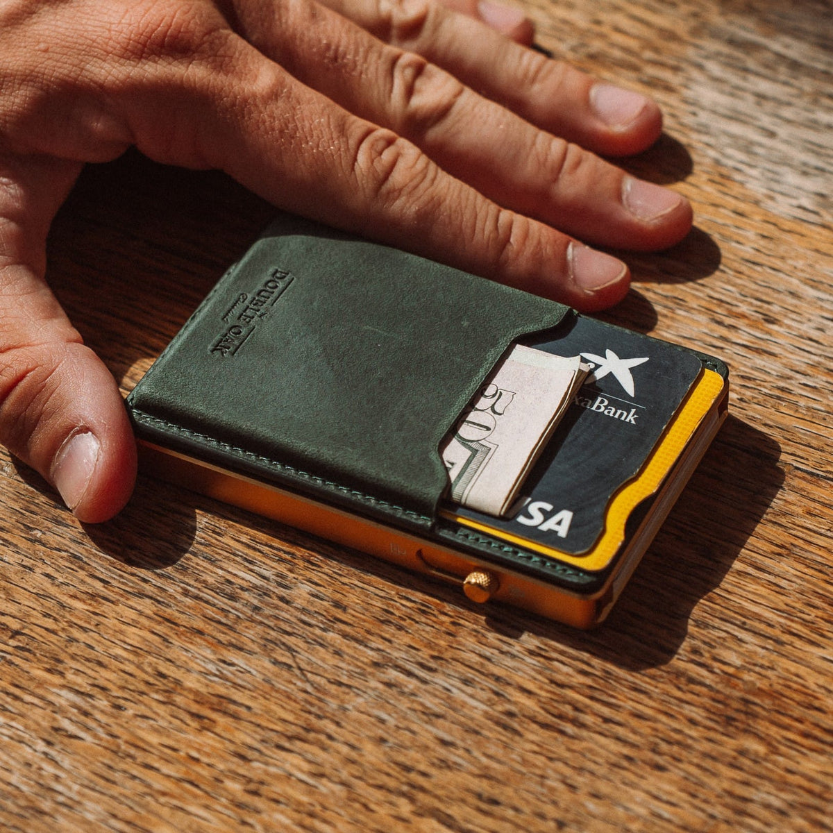 Dark green leather mod wallet with exposed cards and gold-tone base clasp