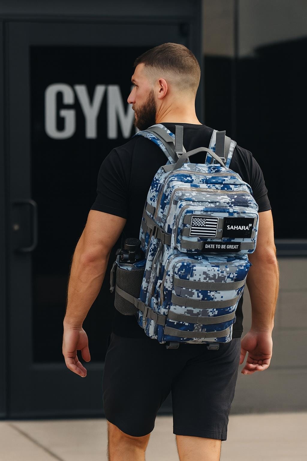 Blue digital camo backpack worn on person, front patch panel and adjustable shoulder straps