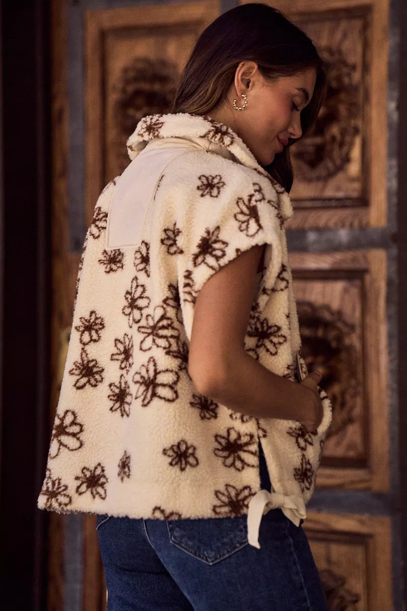 Oversized sleeveless sherpa vest jacket back view, cream with dark brown floral pattern