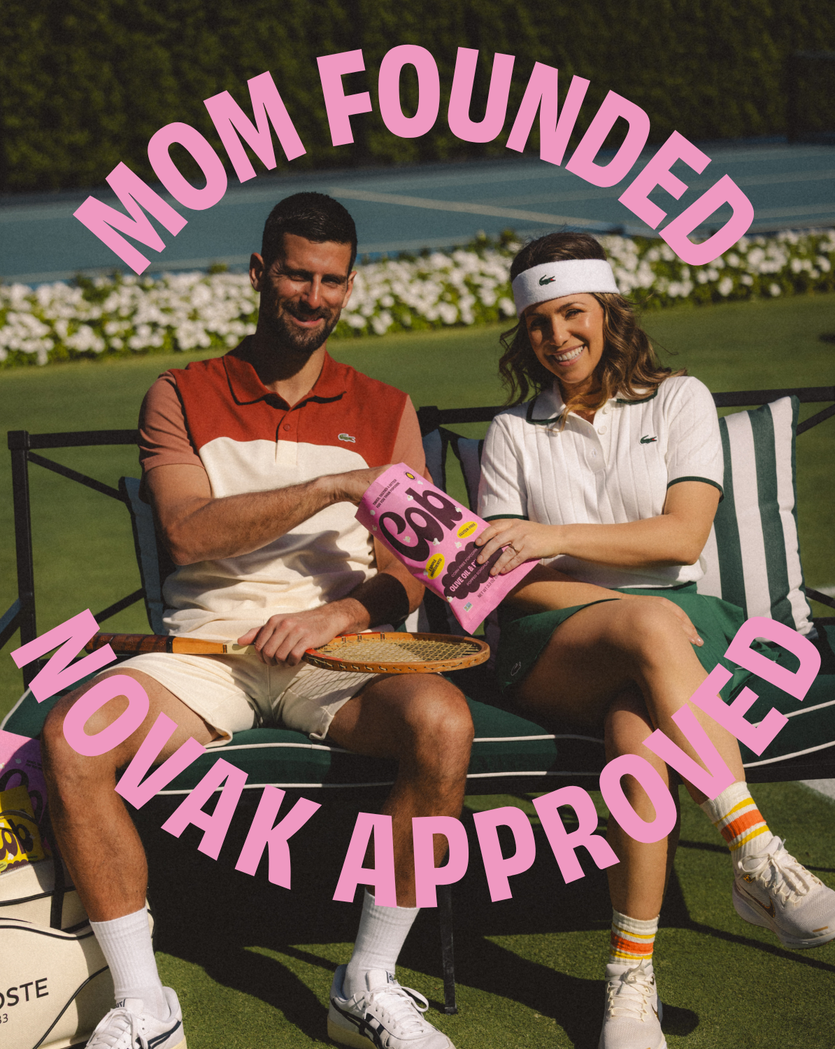 People sitting on a bench holding Cob popcorn snack bag with pink pouch.
