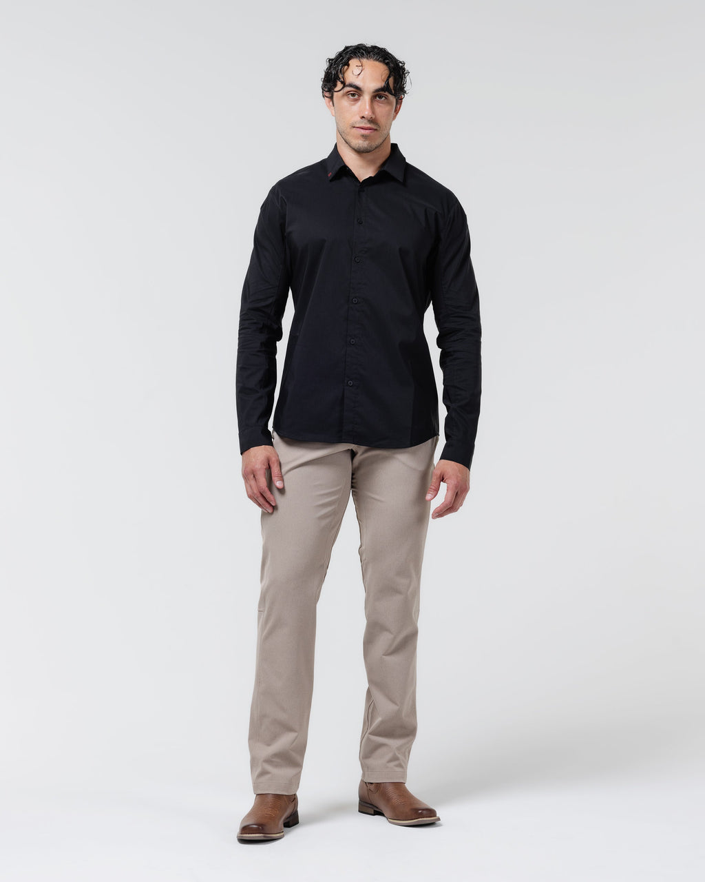 Tan chino pants on model, full-length straight-leg fit