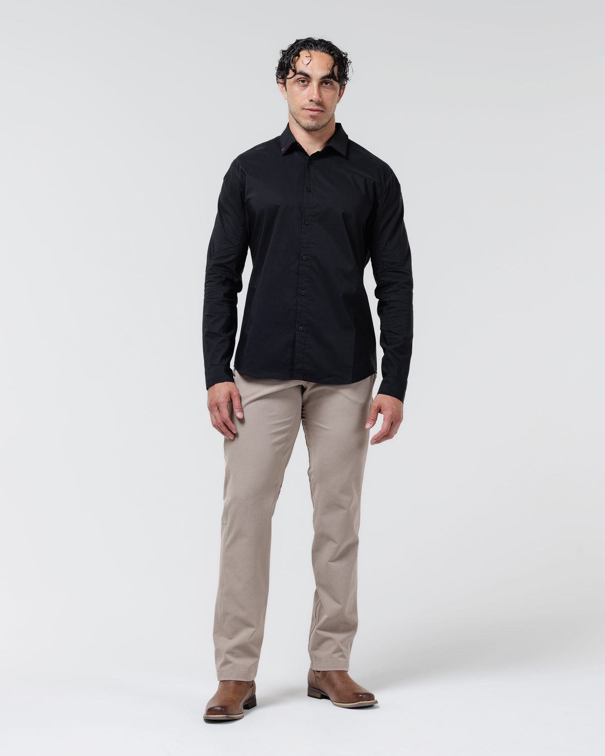Tan chino pants on model, full-length straight-leg fit