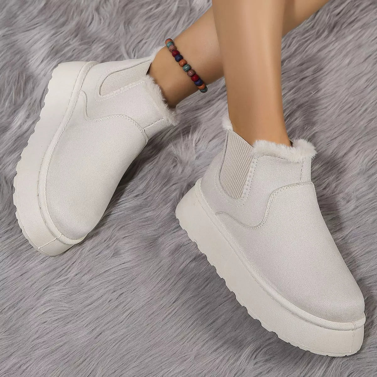 Light beige round-toe platform ankle boots with faux-fur trim and side gore