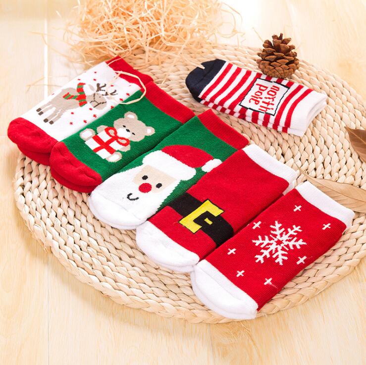 Children's cotton Christmas crew socks with red, green, and white holiday character prints