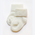 Cream children's non-slip socks with grippy dot pattern on the sole