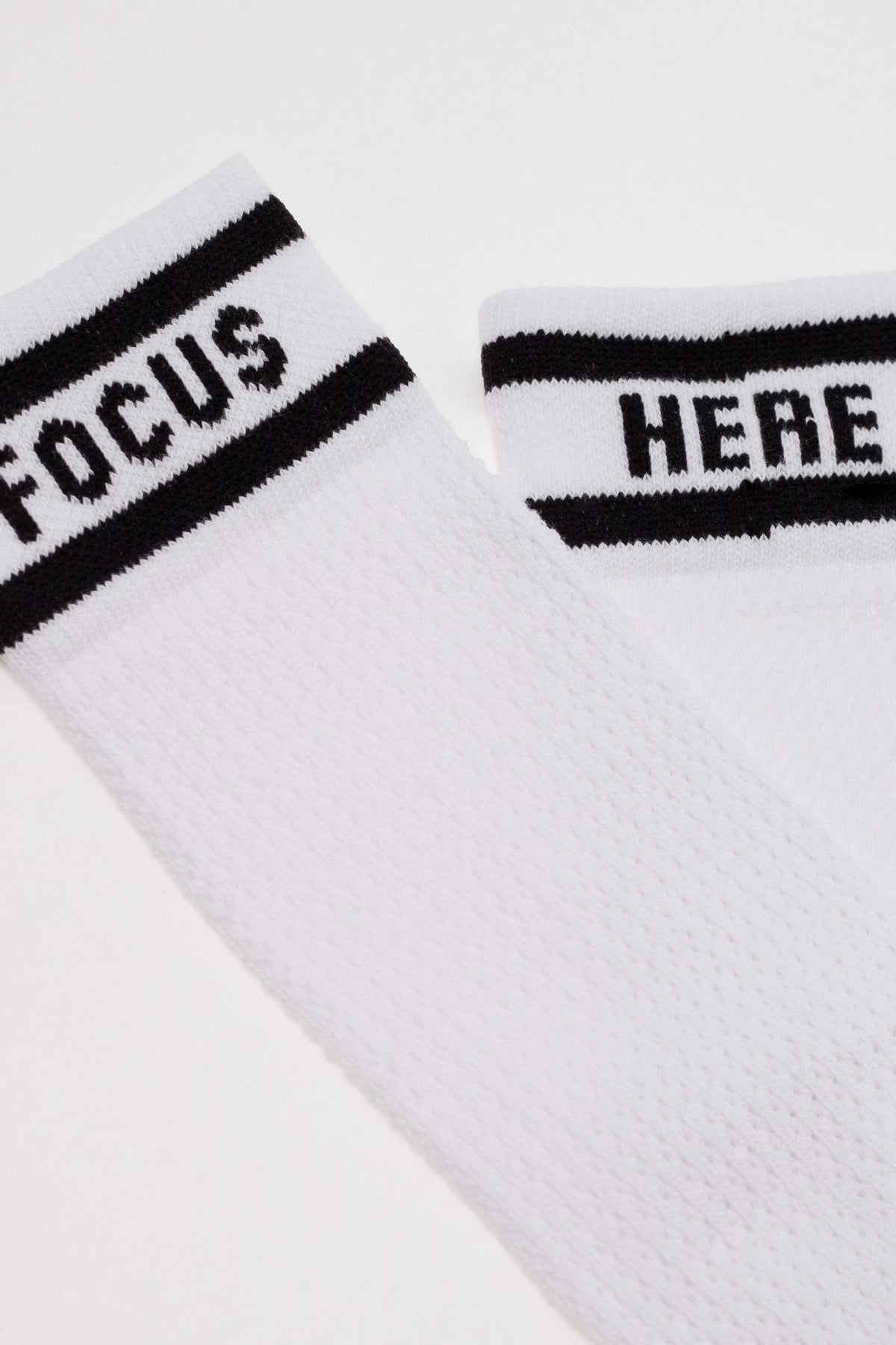White long cotton socks close-up of mesh knit and 'FOCUS' cuff band