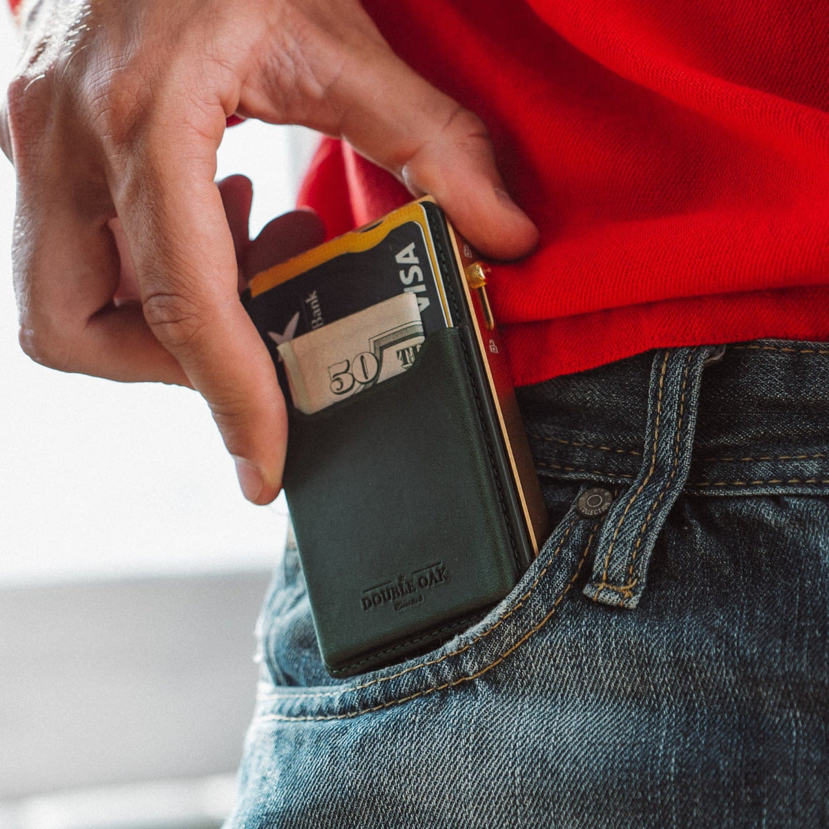 Dark green leather mod wallet clipped with cards, gold-tone metal frame