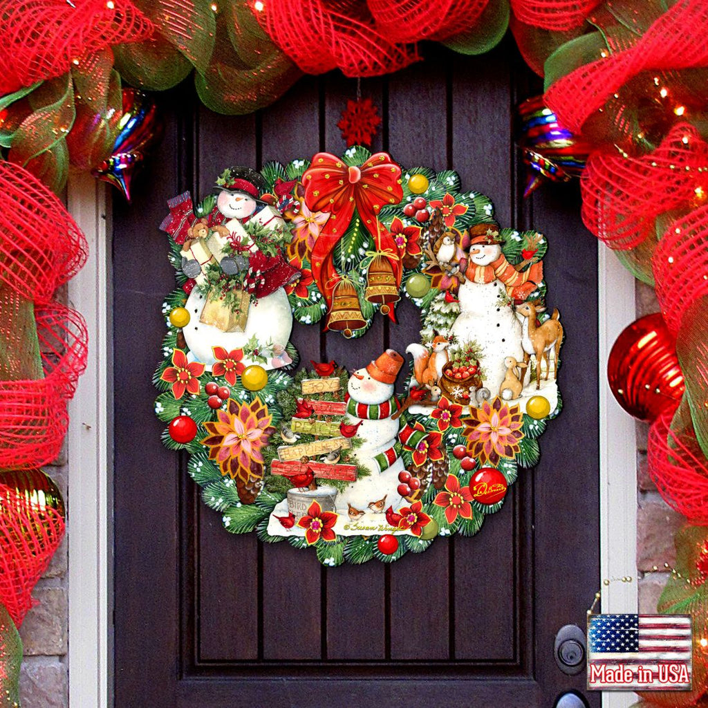 Decorative Christmas door wreath with snowmen, Santa, red bow, and pine accents