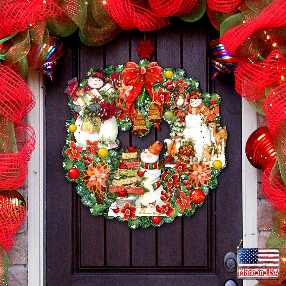 Decorative Christmas door wreath with snowmen, Santa, red bow, and pine accents