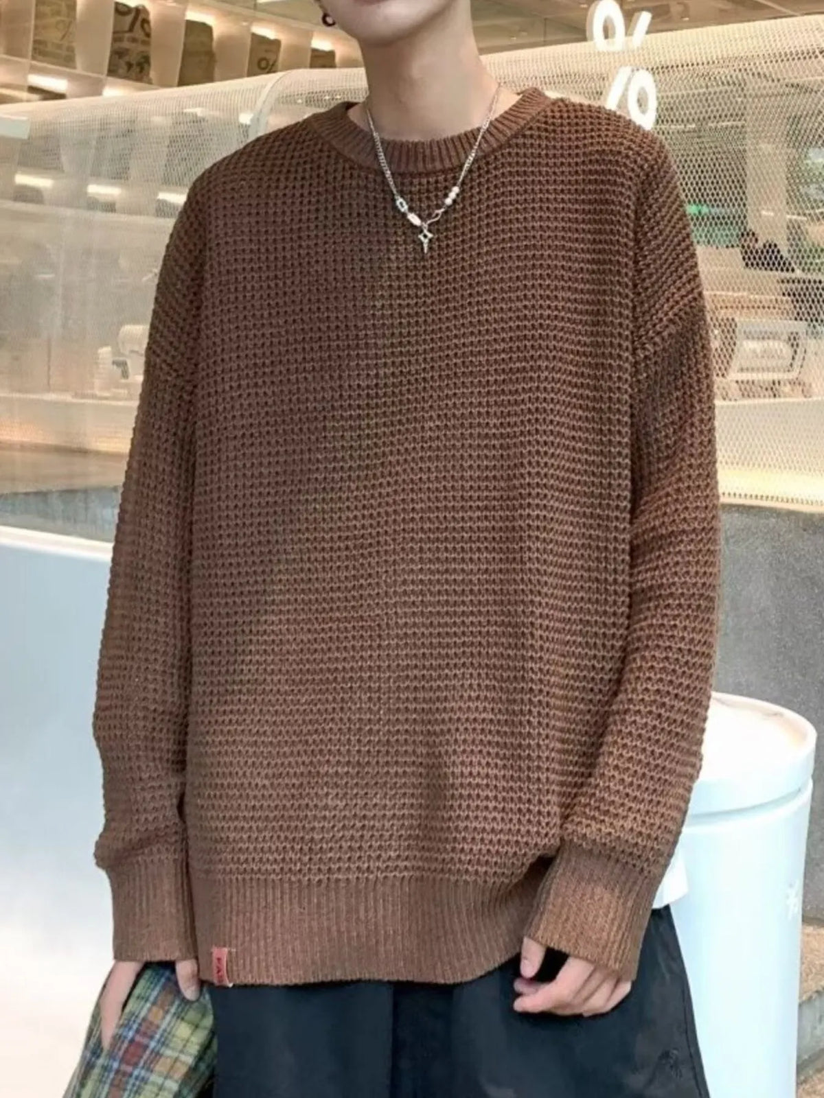 Brown waffle-knit crewneck sweater, long sleeves, ribbed cuffs and hem