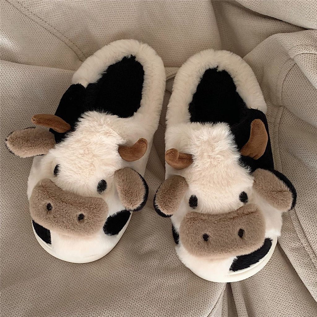 Plush cow house slippers in black-and-white with brown ear details and soft padded lining