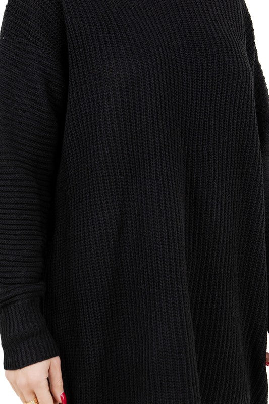 Black knit sweater dress fabric close-up with ribbed texture