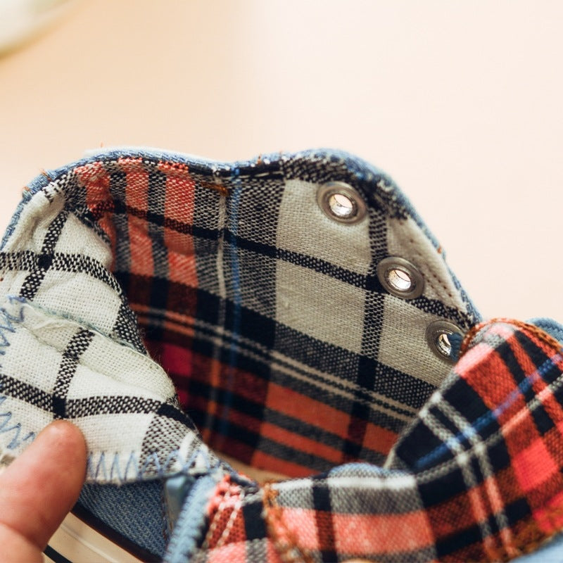 Close-up of light blue high-top sneaker collar with plaid lining and metal eyelets