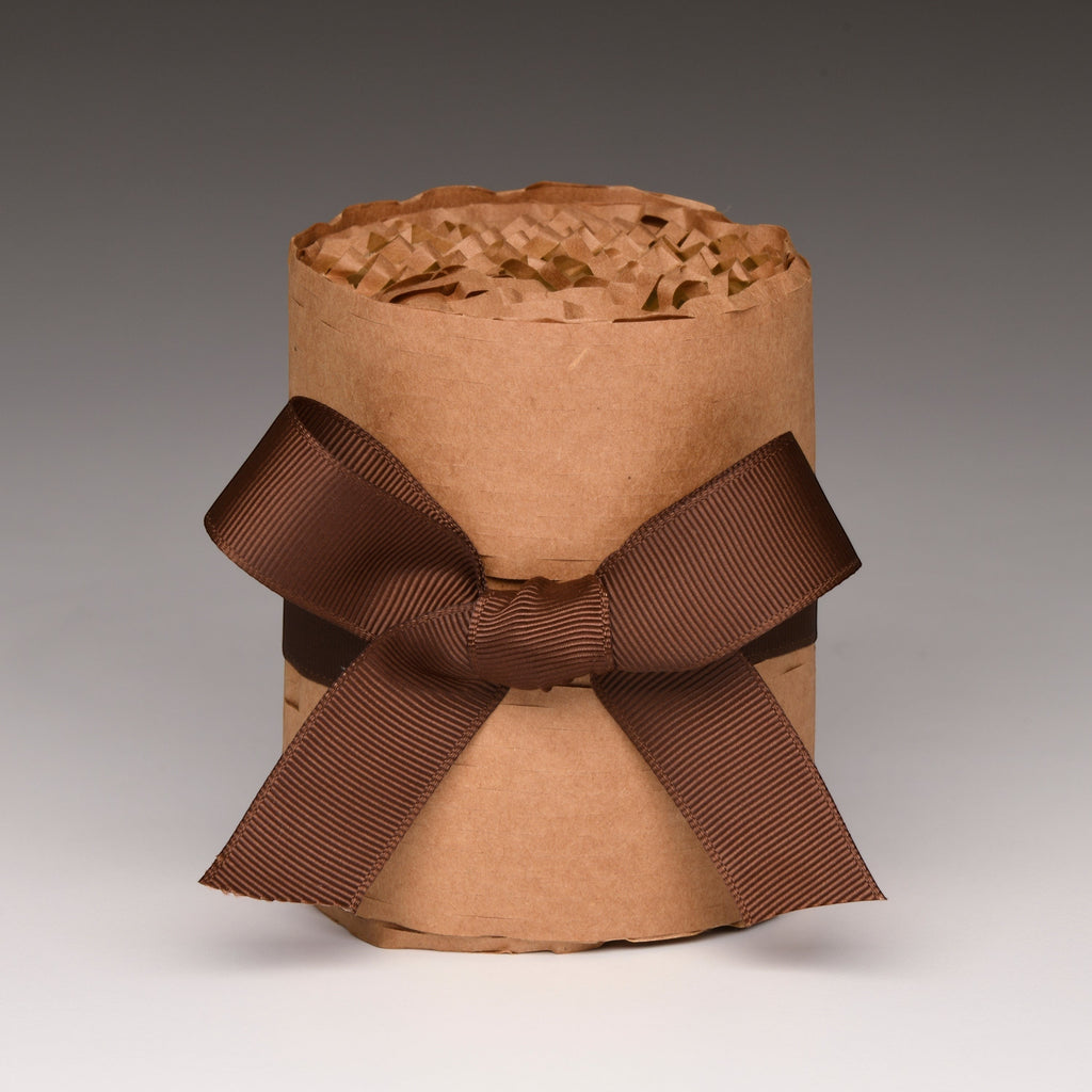 Kraft paper candle jar wrap with brown ribbon and bow, unlit