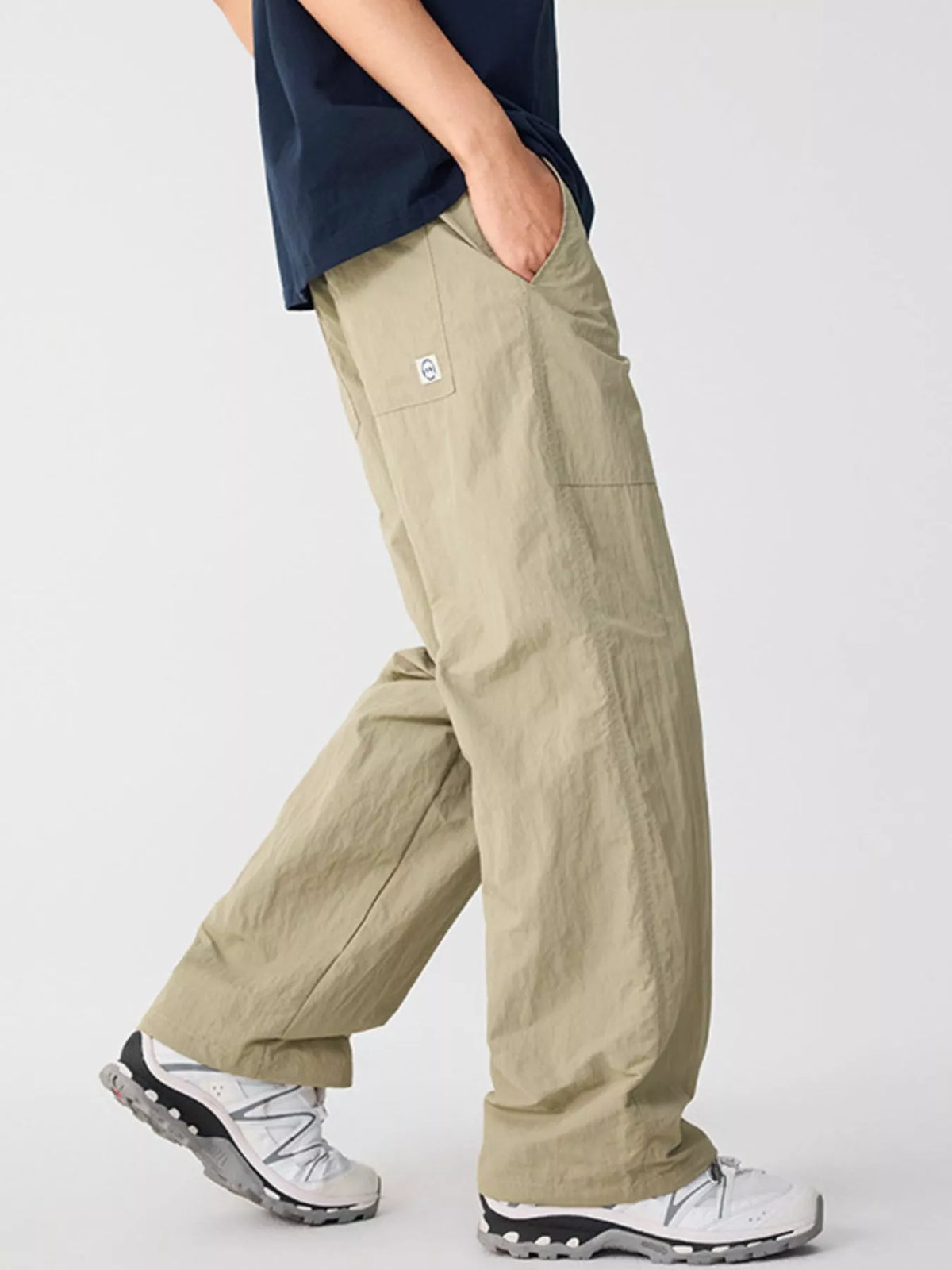 Khaki loose-fit casual pants with cargo pockets and adjustable ankle cuffs