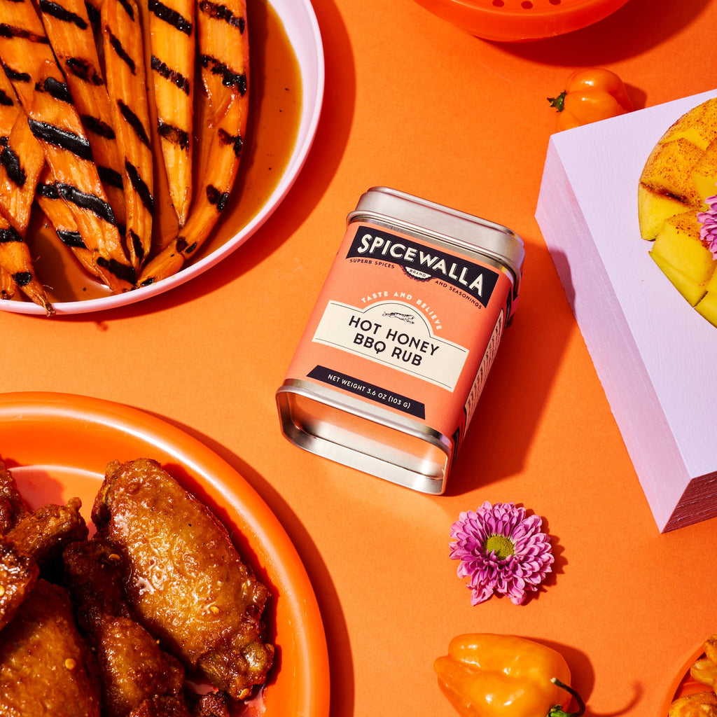 Spicewalla Hot Honey BBQ Rub seasoning can with orange label on metal tin.