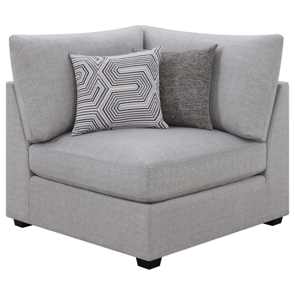Grey upholstered chaise-style sectional end with patterned and solid throw pillows
