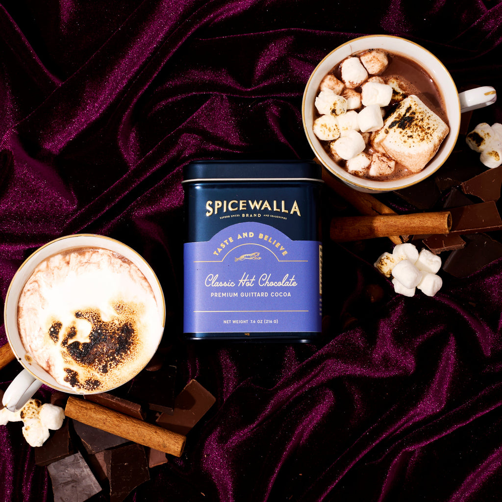 Spicewalla Classic hot chocolate cocoa blend tin with cup topped with marshmallow and cocoa