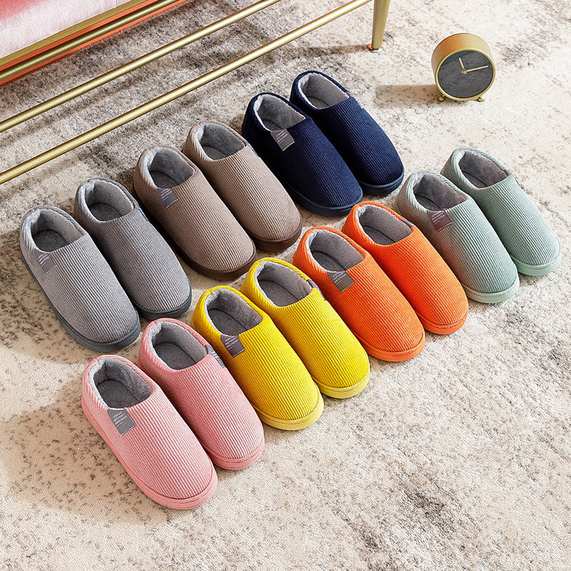 Assorted color corduroy slip-on slippers with gray fuzzy lining and flat soles.