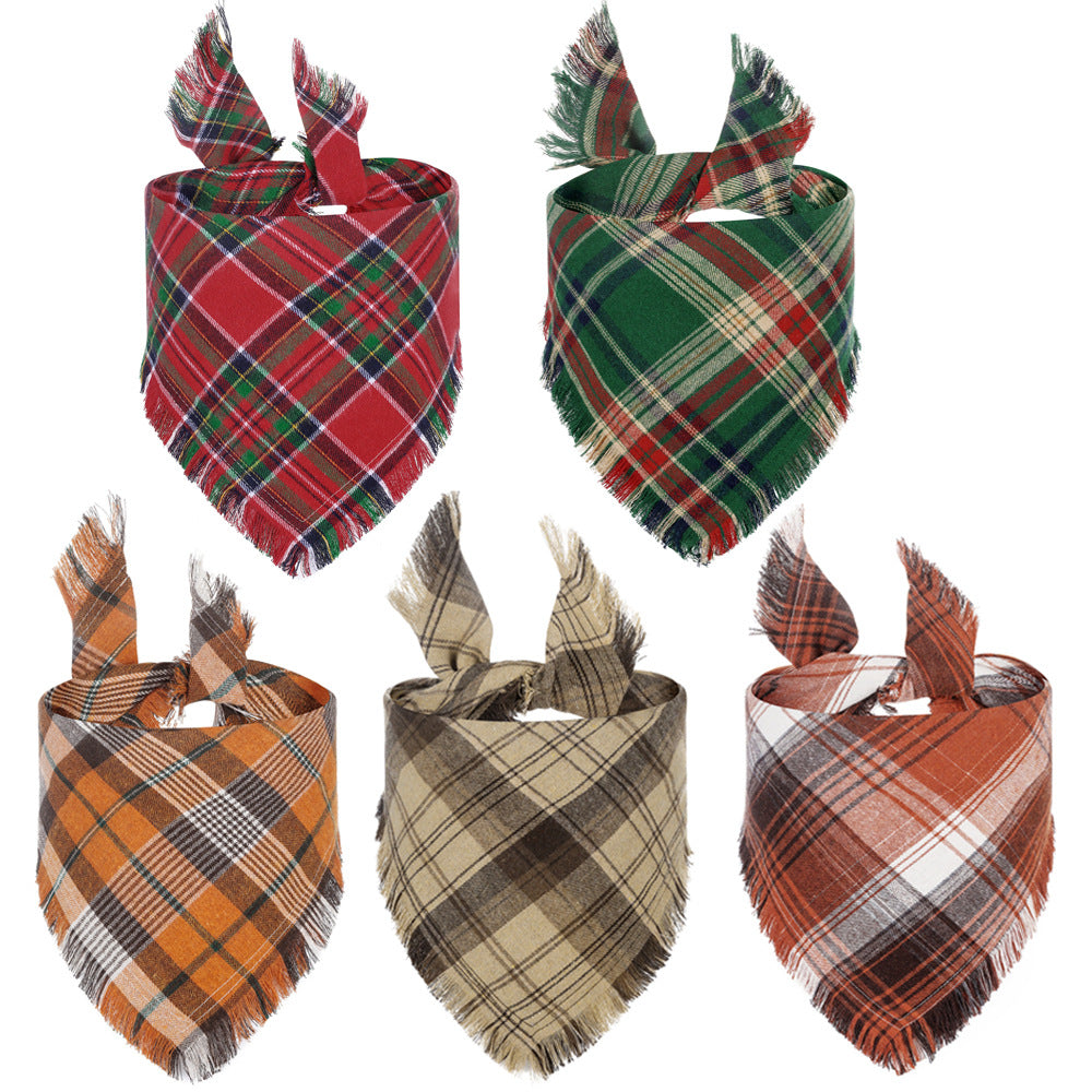 Assorted plaid triangle dog bandanas with tassel edges in red, green, tan, and orange