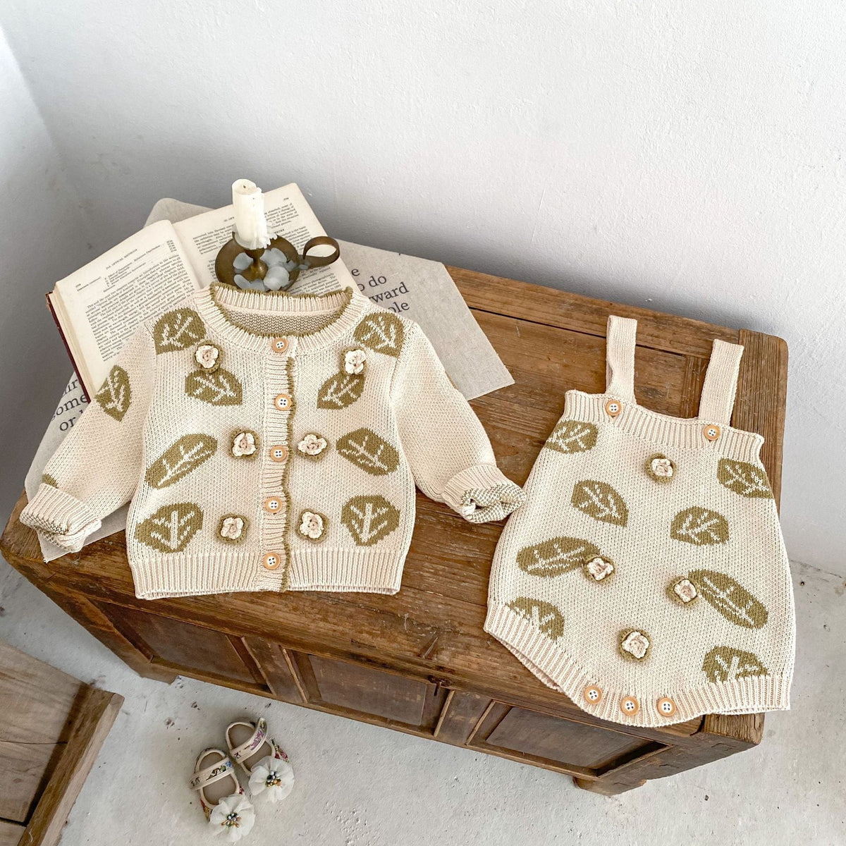 Cream leaf-jacquard knit cardigan and matching suspender skirt set, front view on display