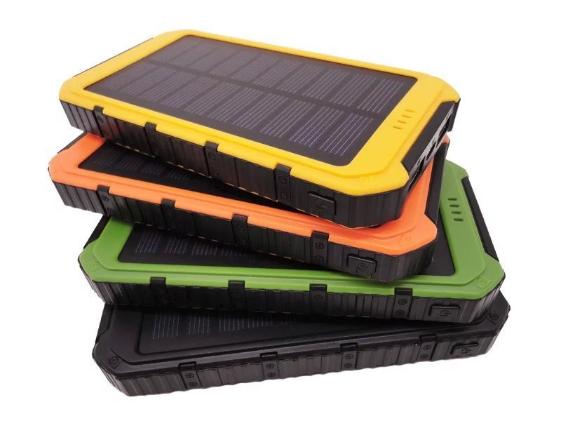 Stacked rugged solar power banks with solar panels in yellow, orange, and green layers.