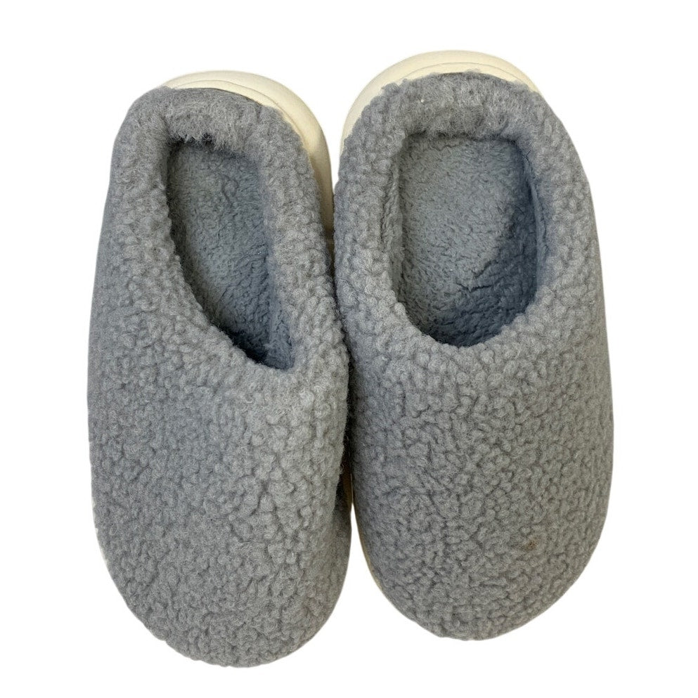 Pair of gray fuzzy closed-toe slippers showing inner lining and cream rim