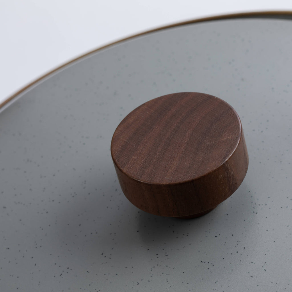 Enamel stock pot lid knob detail, round wood-look knob on light gray lid