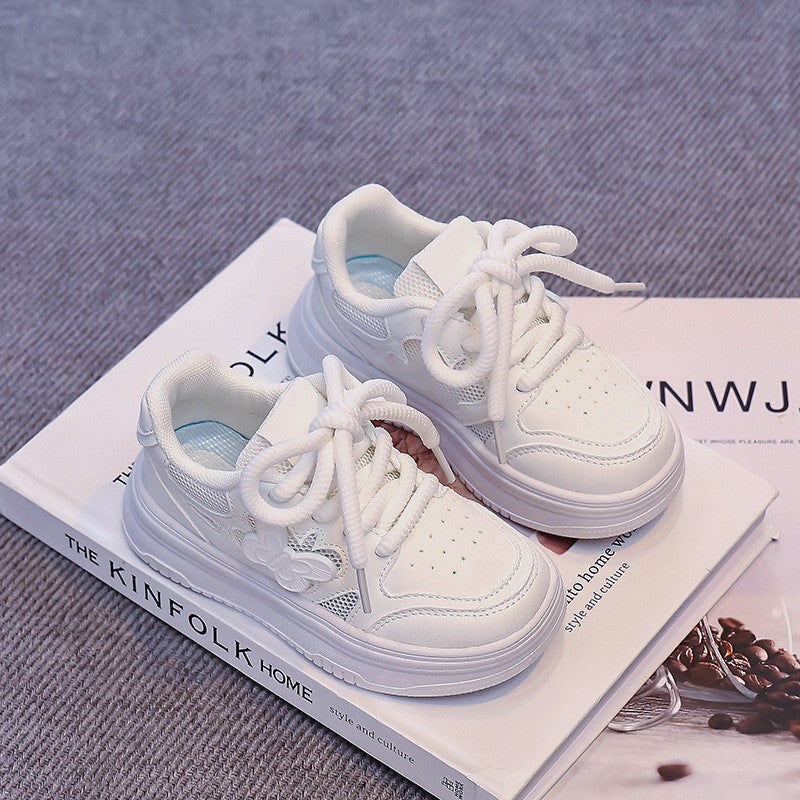White kids' mesh skate sneakers with lace-up front and thick rubber sole, angled pair.