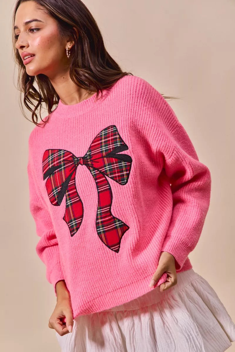 Pink knit sweater with plaid bow ribbon applique and ribbed cuffs