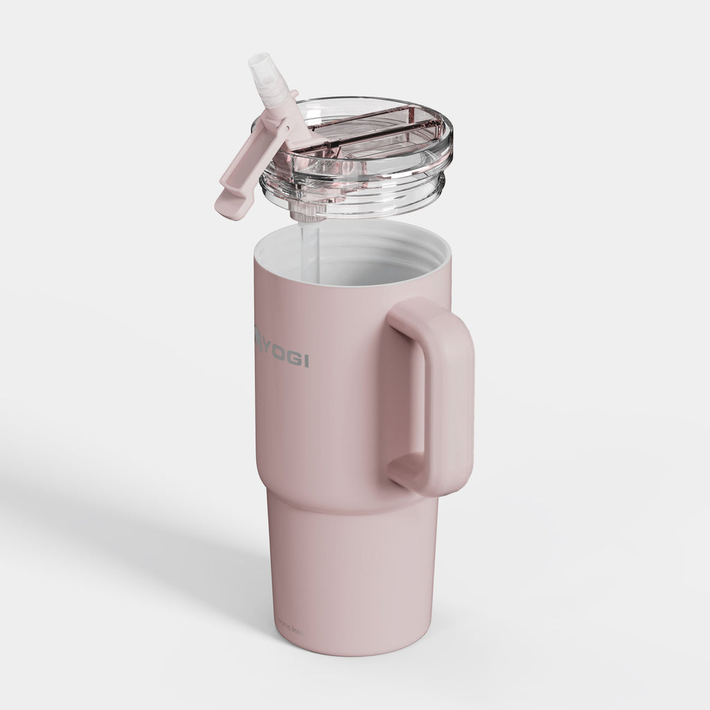 Ceramic-lined tumbler in pale pink with handle and open clear lid, shown from side.