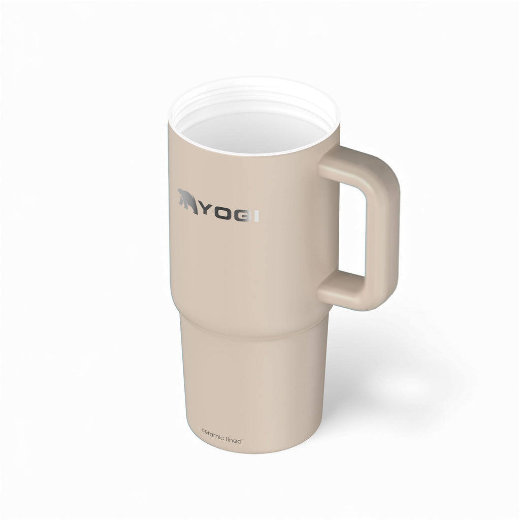 Ceramic-lined tumbler with open top and side handle, light cream color