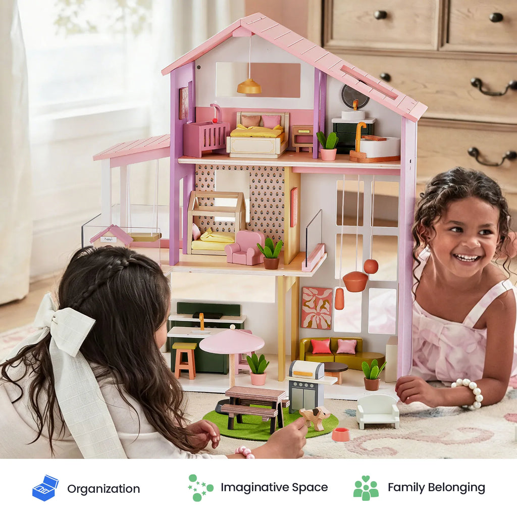 Pink dollhouse with open rooms, balcony railing, and furnished play areas