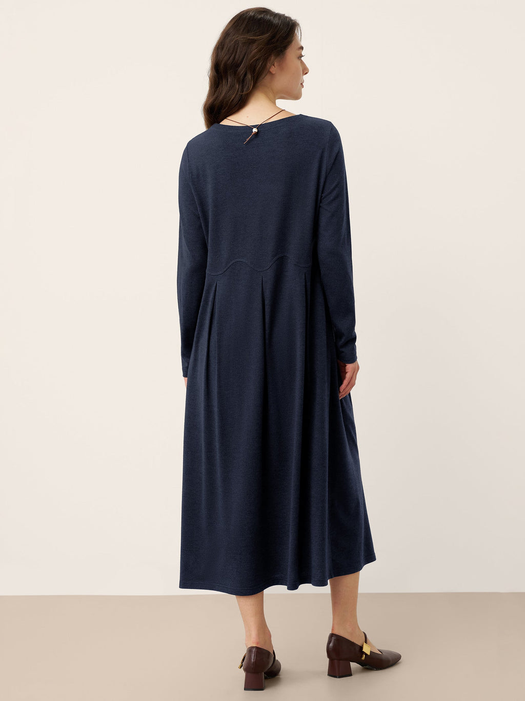 CALISTA navy wool midi dress, back view, arc panel pleats and long sleeves