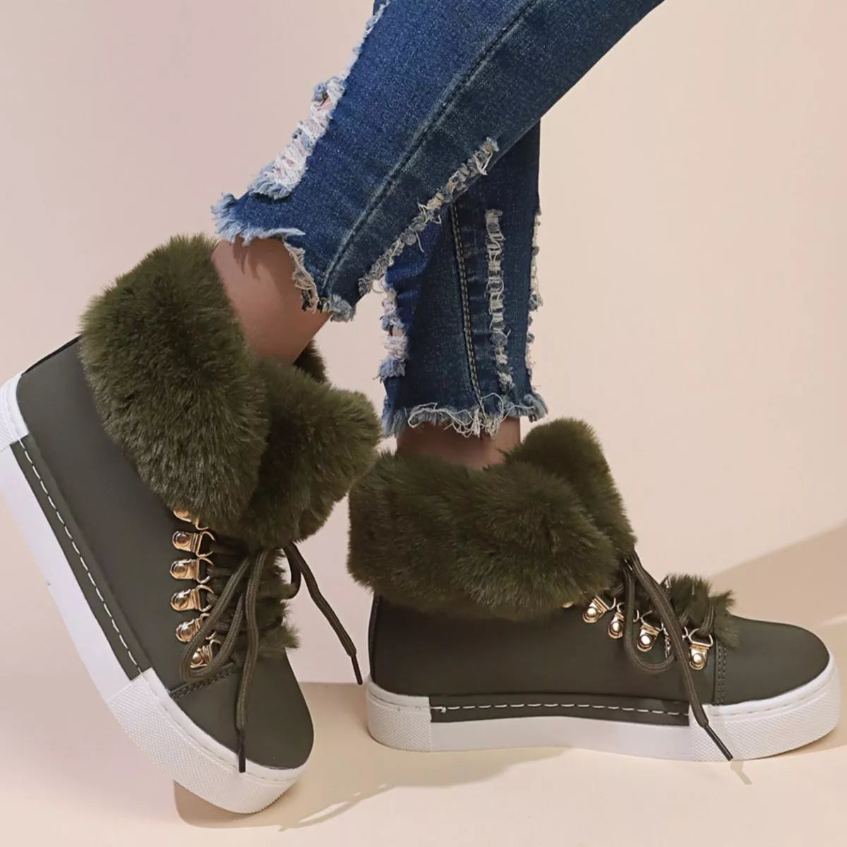 Green lace-up ankle boots with fluffy fur cuff and gold lace-up eyelets