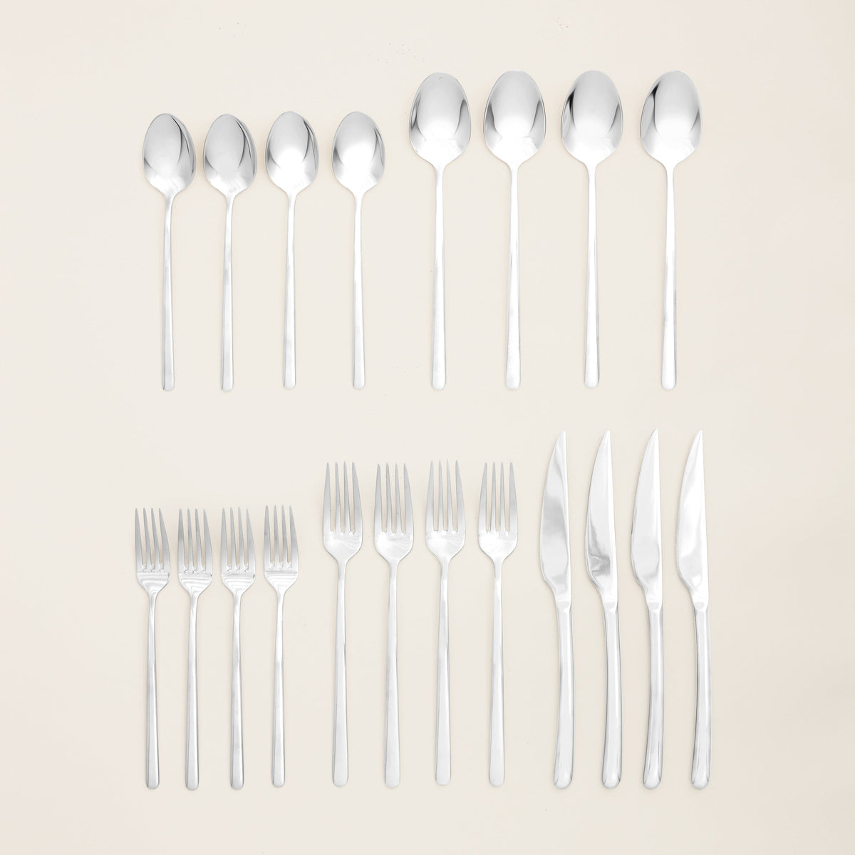 Silver mirror-finish 20-piece flatware set, arranged forks and spoons