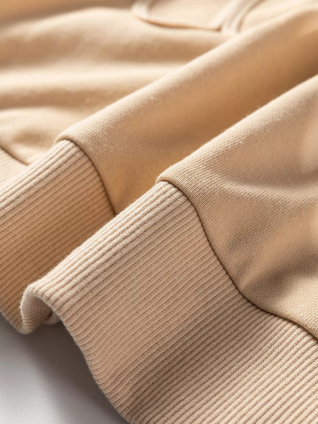 Beige ribbed cuff and sleeve knit on drop-shoulder sweatshirt