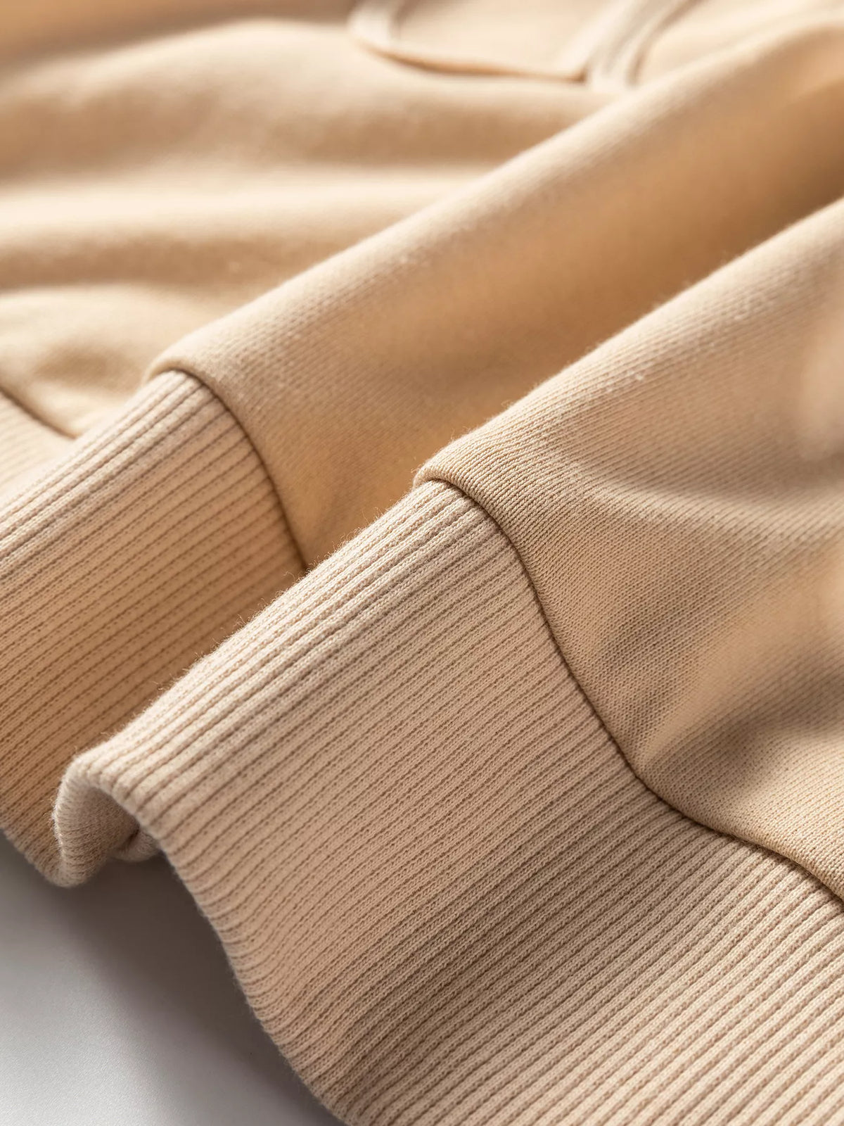 Beige ribbed cuff and sleeve knit on drop-shoulder sweatshirt