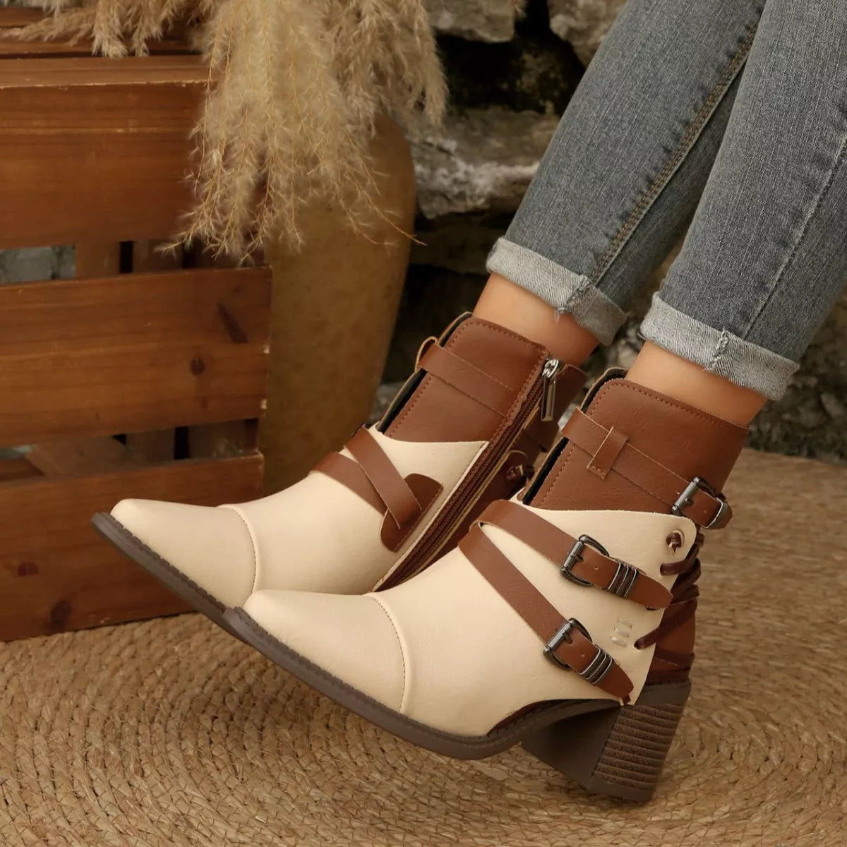 Front angle two-tone ankle boots with point toe, side zipper, buckled straps, block heel