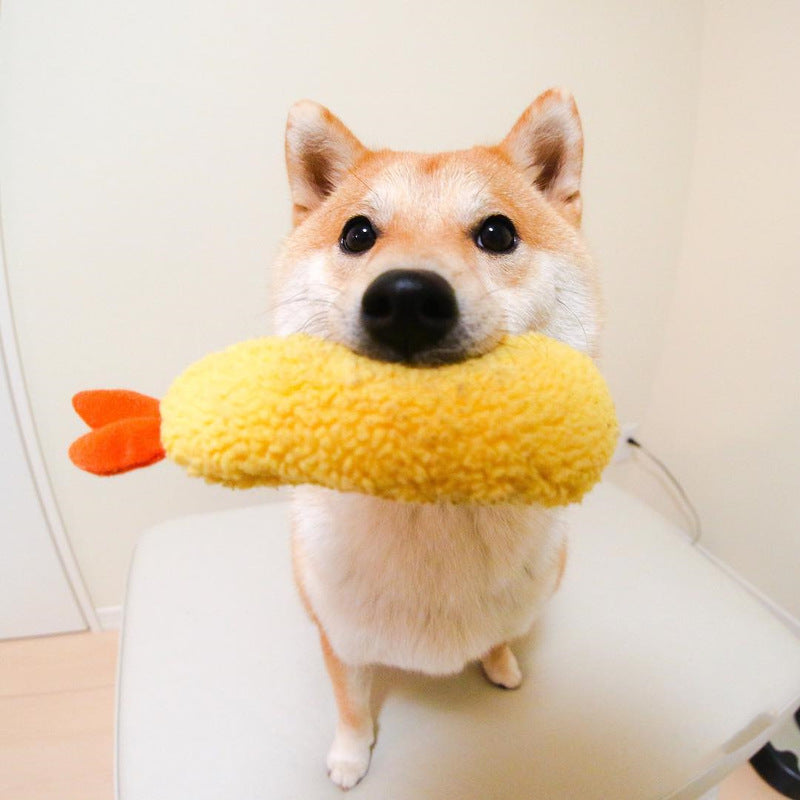 Stuffed yellow shrimp-shaped pet chew toy with orange tail and squeaker