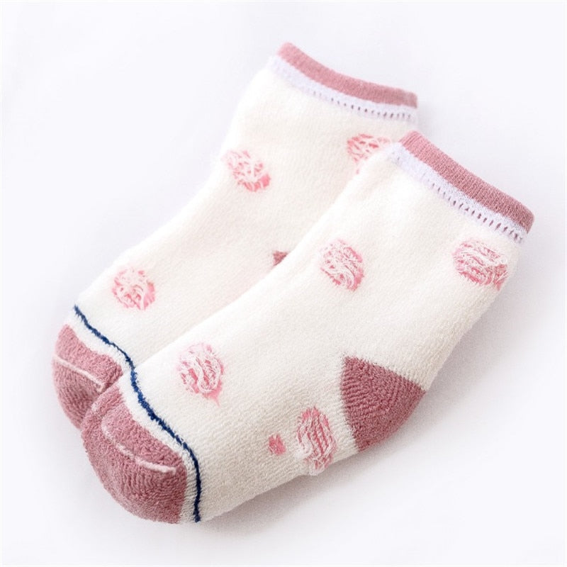 Children's terry socks with white base and pink heart pattern, pink trim