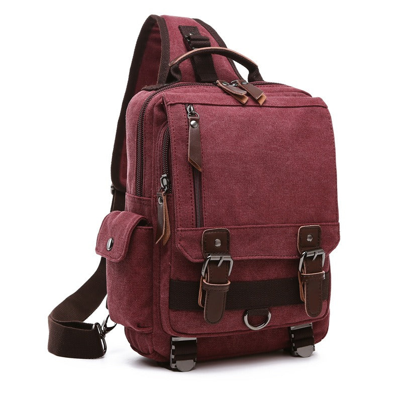Burgundy canvas backpack with top handle, front flap pocket, and front zip closure