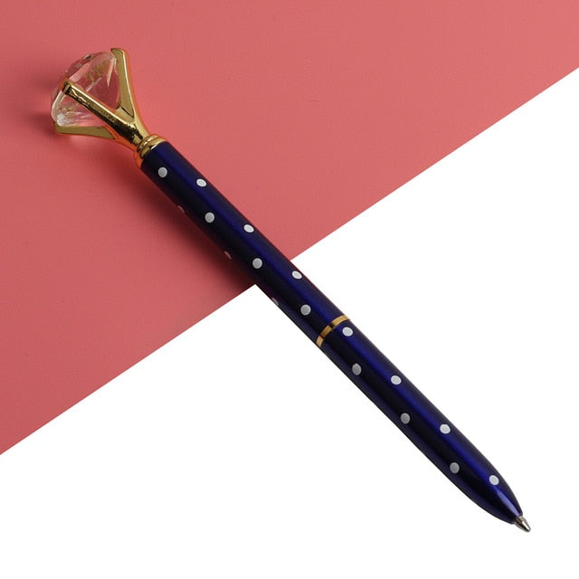 Kawaii ballpoint pen with black barrel, blue dots, and gold gem-style cap