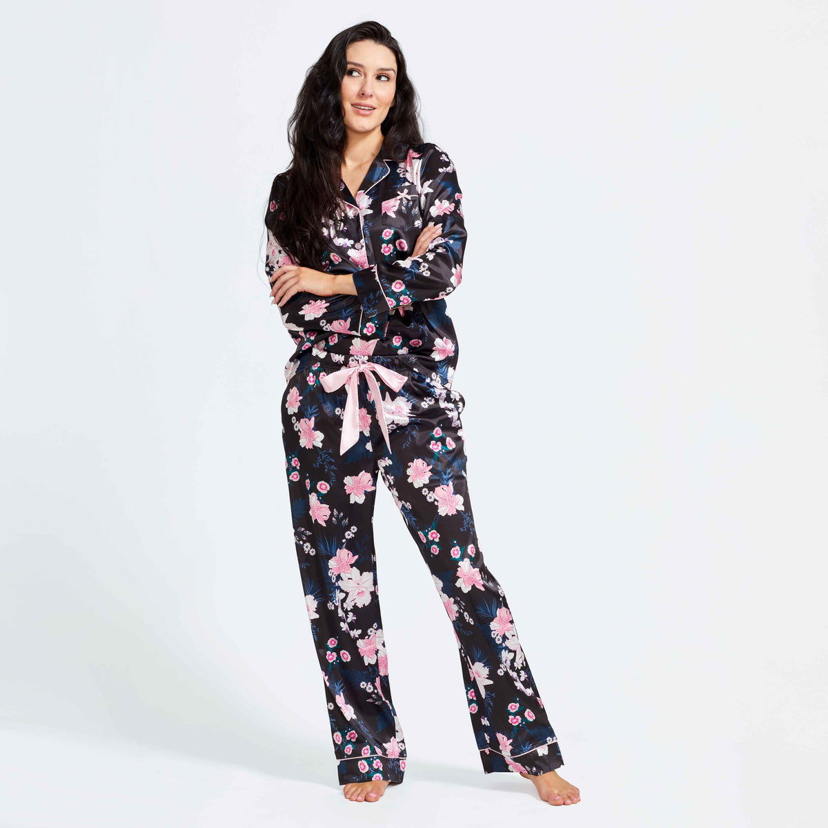 Black satin floral pajama set: button-up top and matching pants with ribbon tie