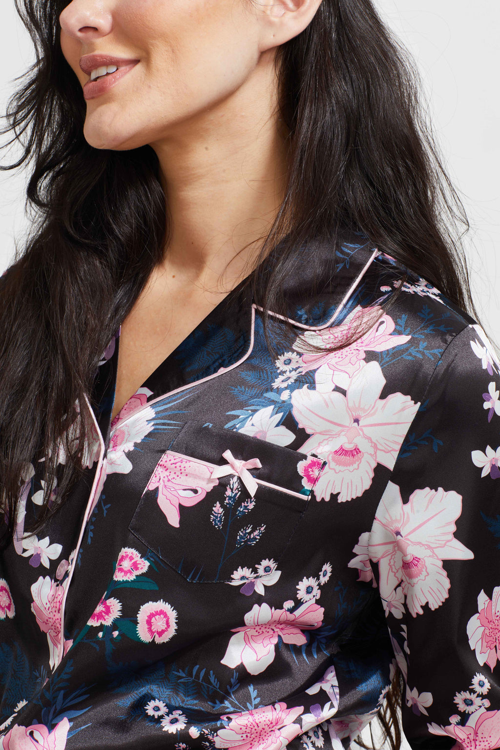 Black floral satin pajama top close-up with V-neck and long sleeves