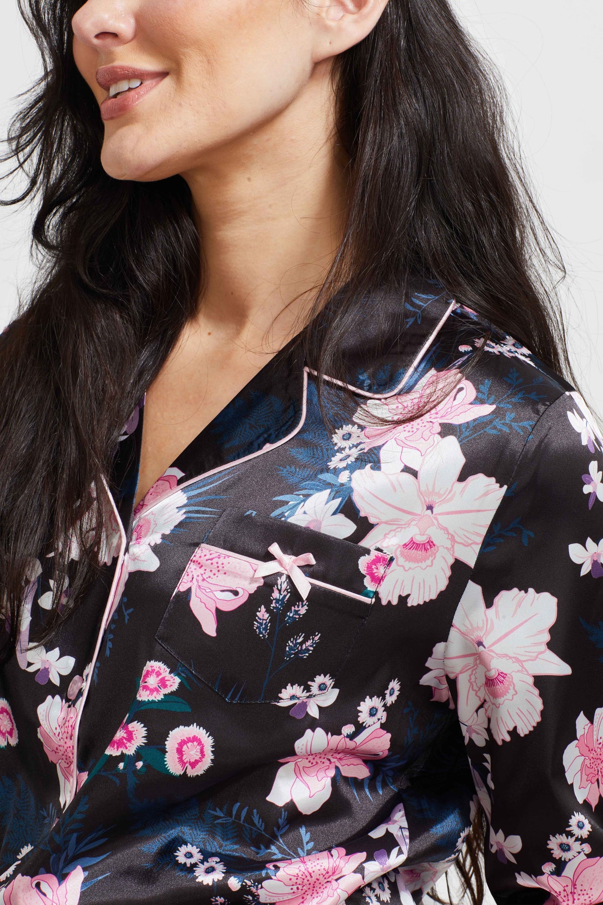 Black floral satin pajama top close-up with V-neck and long sleeves