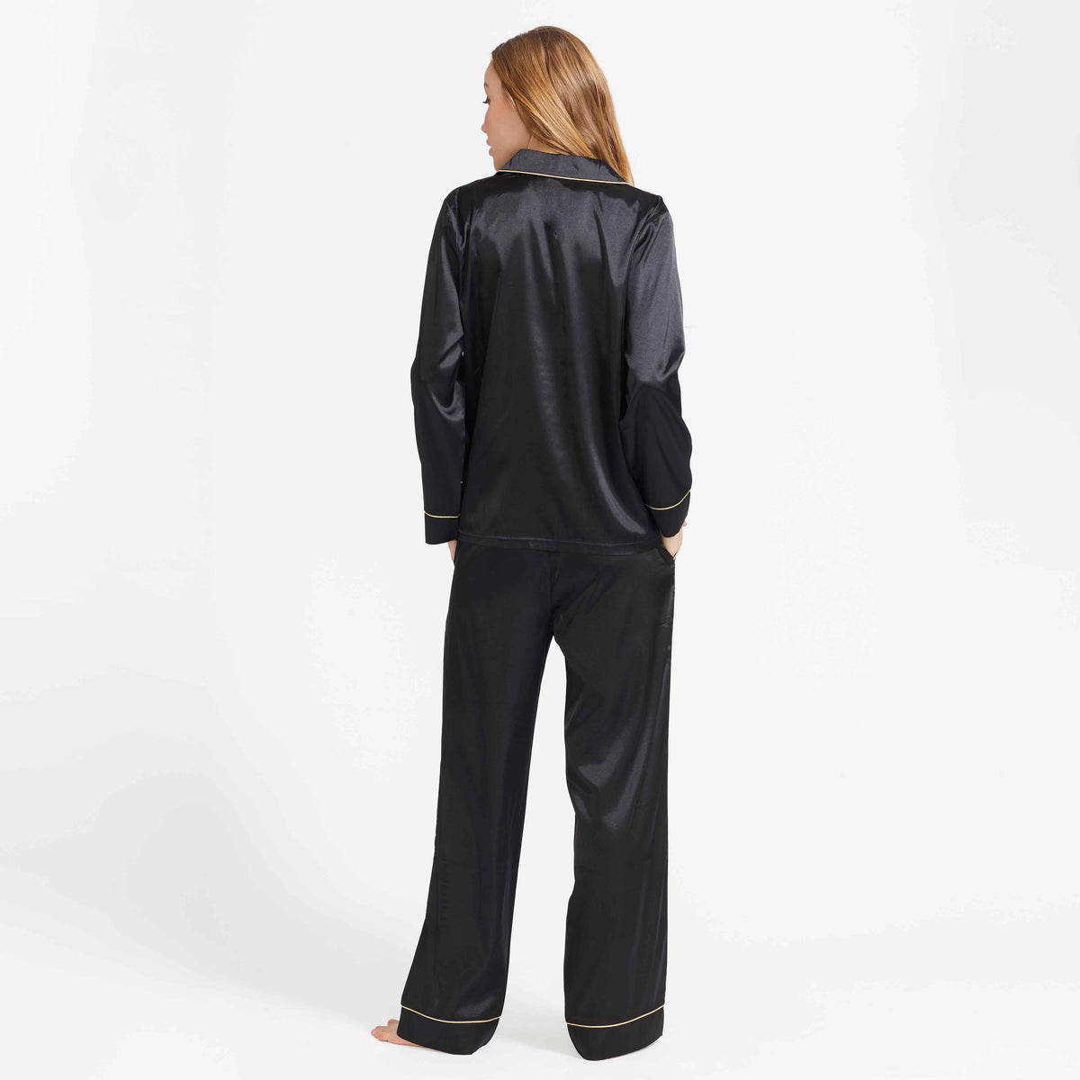 Black satin pajama set with back button placket and gold-trim piping