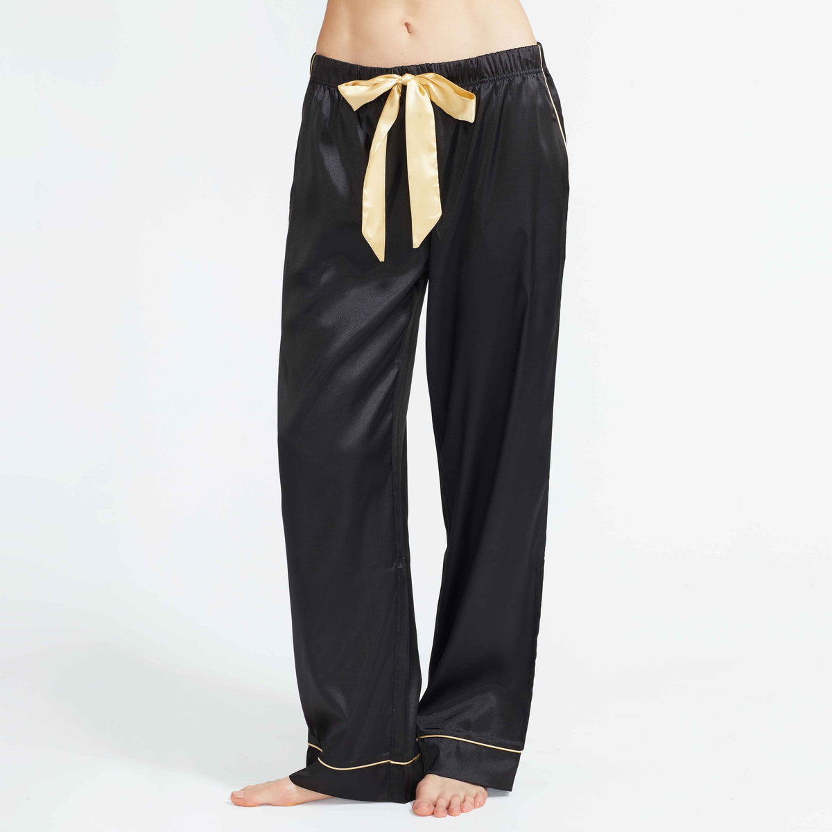 Black satin pajama pants with elastic waist and gold ribbon bow